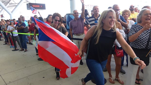 Families of Caribbean hurricane evacuees who arrived on board the Royal Caribbean Adventure of the Seas rush to greet their relatives,