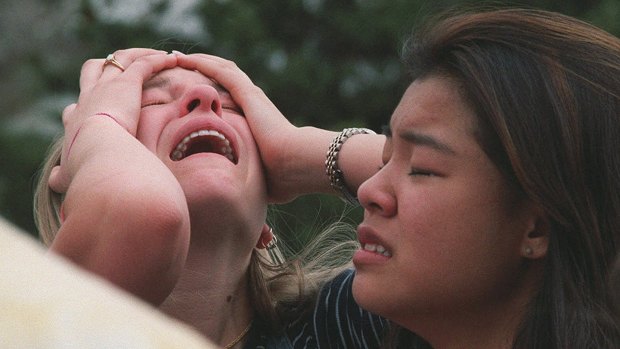 Columbine High School students overwhelmed after a shooting rampage by two students in 1999. 