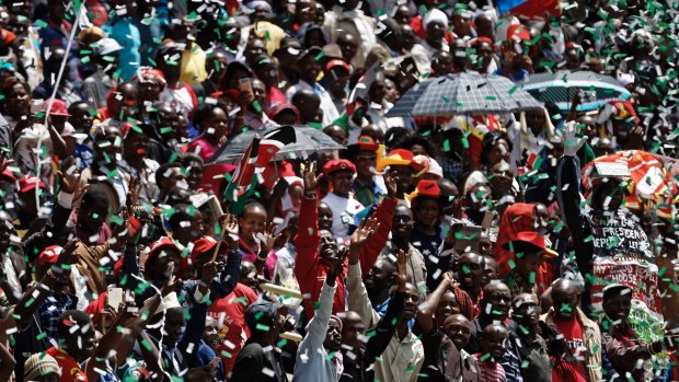 Supporters cheer in the stands as Kenyan President Uhuru Kenyatta is sworn in.