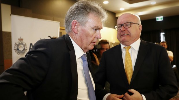 ASIO Director General Duncan Lewis and Attorney-General George Brandis during AFP Commissioner Andrew Colvin's address to the National Press Club of Australia in Canberra on Wednesday.