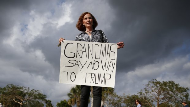 Mary Dickens holds a sign outside a Republican presidential candidate Donald Trump campaign rally in Florida on Sunday. 