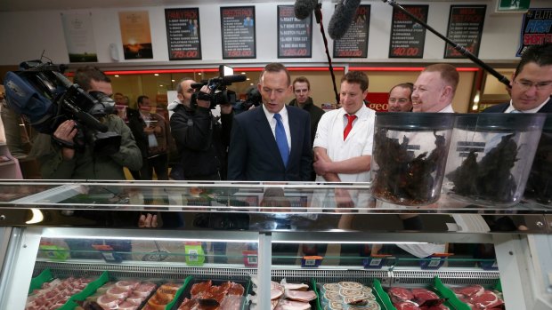 Prime Minister Tony Abbott during his visit to a butcher's shop.