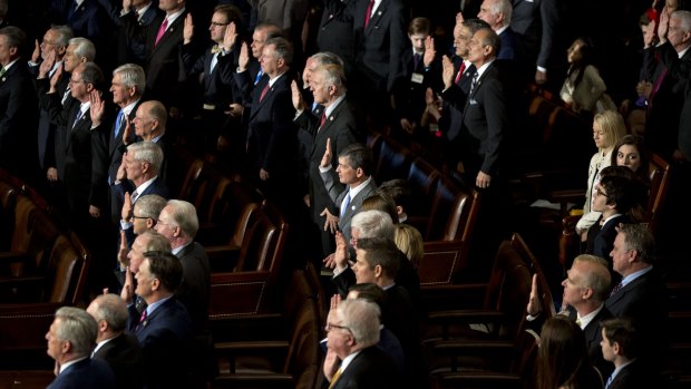 Republican House representatives are sworn-in en masse by US House Speaker Paul Ryan on Tuesday.