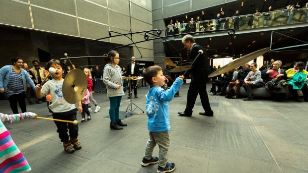 Children interact with Mexican artist Carlos Amorales' installation in the foyer of NGV International.