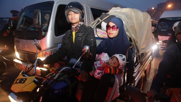A family rides to their home village in Bekasi on the outskirts of Jakarta, with gifts for the end of Ramadan in tow.