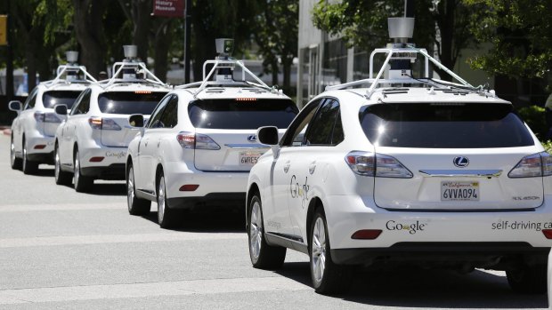 A row of Google self-driving cars stands outside the Computer History Museum in Mountain View, California.