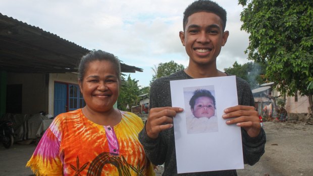 Pedro Unamet Remejio, right, was born in 1999 during the height of independence violence. Pictured here with his mum and holding a picture of himself as a baby.