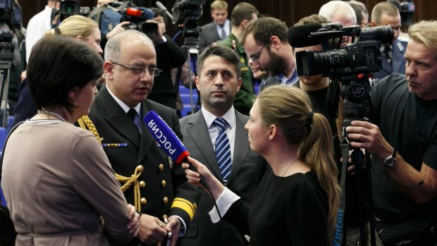 Turkish defence attache Ahmet Hakam Gunes, second left, speaks to the media after the presentation of images of oil trucks near Turkey's border with Syria were displayed by the Russian Defence Ministry at a briefing in Moscow, Russia, Wednesday.