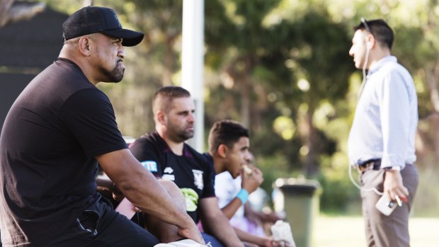 Sidelined: John Hopoate watches from the sidelines as Manly's SG Ball team trains last week.