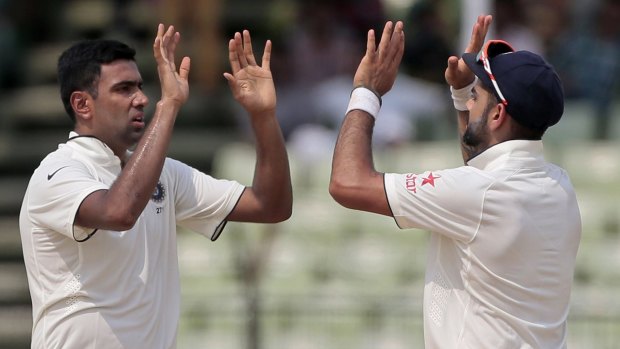 Ravi Ashwin and India captain Virat Kohli celebrate the dismissal of Bangladesh's Shuvagata Hom.