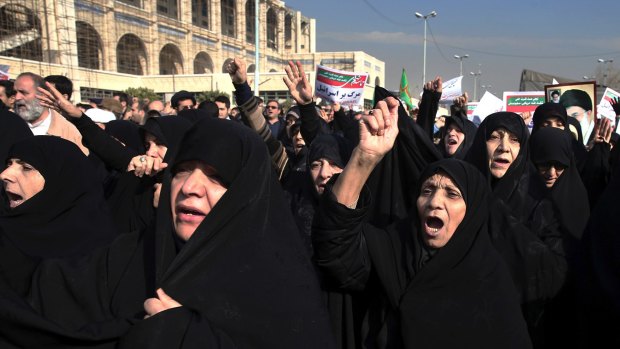 Government supporters chant slogans at a rally in Tehran on Saturday. Iranian hard-liners rallied Saturday to support the country's supreme leader.
