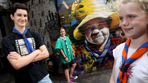 Scouts (L-R) Sam, Matilda and Tamsin pose for a photo on Stevensons Lane ahead of the scouts 'Wide Games'.The 'Wide Games' involves scouts searching around the city for specially painted pieces of street art. 