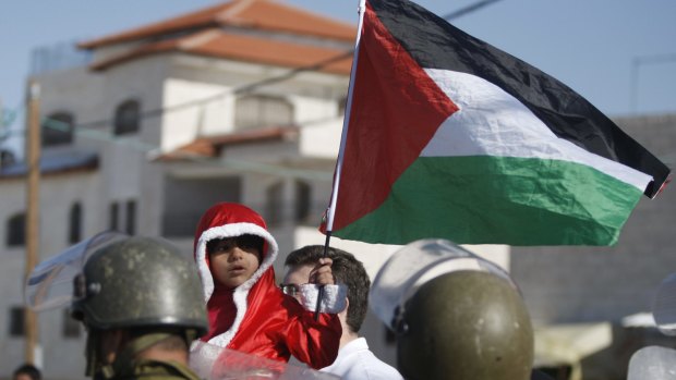 The Palestinian flag held by a child in the West Bank in 2013.