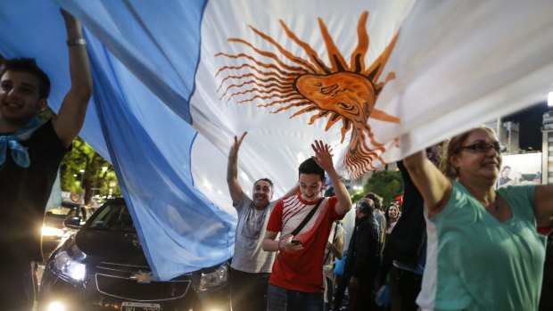 Supporters of opposition presidential candidate Mauricio Macri celebrate at the Plaza de La Republica in Buenos Aires, Argentina on Sunday.