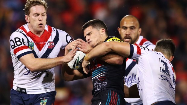 Sandwiched: The Roosters defence latches onto Panthers rookie Nathan Cleary.