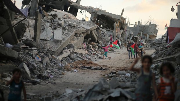 Palestinian children play near the ruins of their houses destroyed during the seven-week Israeli offensive in east Gaza City in September last year.