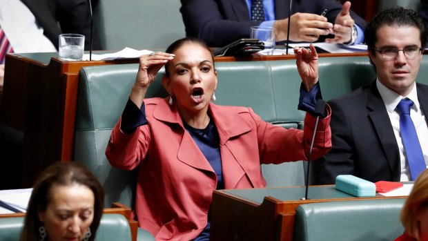 Labor MP Anne Aly listens to Immigration Minister Peter Dutton speak during question time on Thursday.