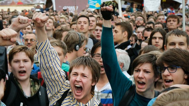 Young protesters  are blocked by riot police during a demonstration in downtown Moscow. In many cases, Putin has run Russia for their entire lives.