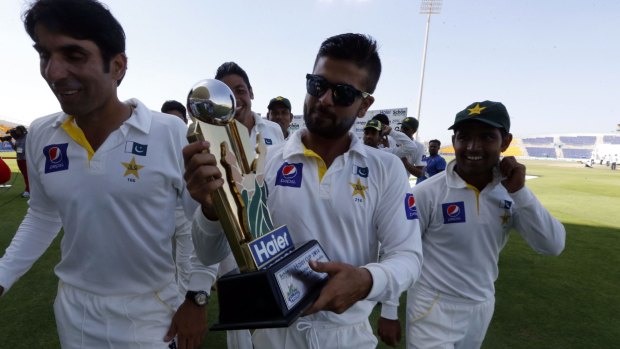Ahmed Shehzad holds the trophy after Pakistan claimed victory.