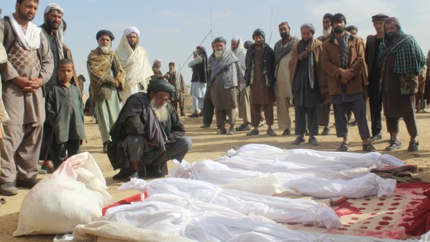 Afghan villagers gather around the bodies of people killed during clashes between Taliban and Afghan security forces in November 2016. Hekmatyar called for an end to the "pointless" war.