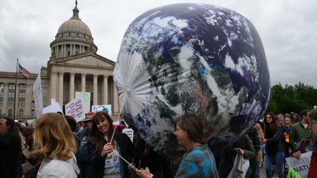 Members of the Oklahoma Nature Conservancy carry an inflatable globe during the March For Science   in Oklahoma City.