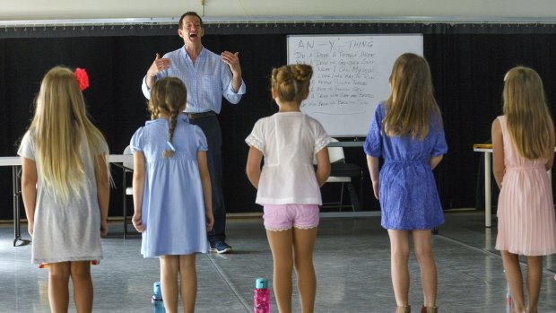 Music director Peter Casey takes children through their paces for The Sound of Music auditions.