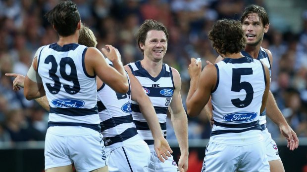 Well done: Patrick Dangerfield is congratulated by teammates after kicking a goal.