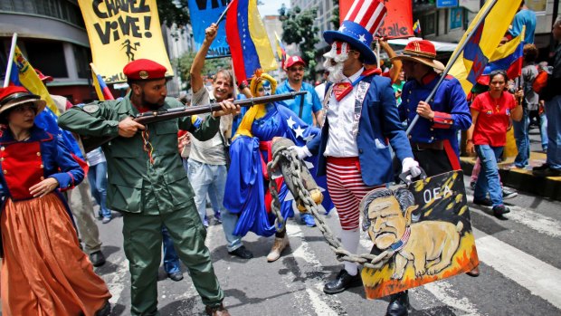 Government supporters perform a parody involving a Venezuelan militia member confronting Uncle Sam, symbolising the US government in Caracas in August 2017.