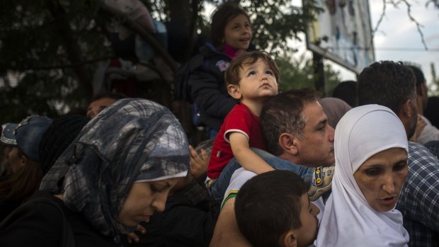 Syrian refugees wait to be registered by police in the southern Serbian town of Presevo on September 11.