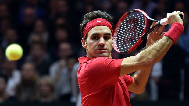 Class act: Roger Federer on his way to sealing the Davis Cup for Switzerland.