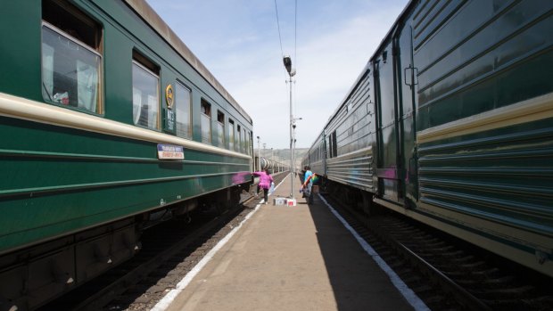 Train carriages wait for a diesel engine at the Russian border port of Naushki, Siberia.