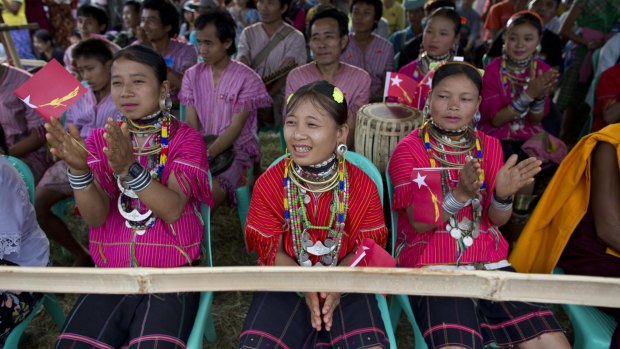 Ethnic Kayaw women in traditional attire applaud as Myanmar's opposition leader Aung San Suu Kyi's delivers a speech in Kayah state on Friday. 