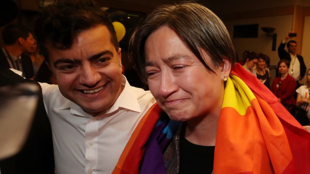An emotional Senator Penny Wong with Senator Sam Dastyari after the result is revealed in the same-sex marriage survey.