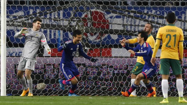 Game changer: Substitute Yasuyuki Konno celebrates giving Japan the lead on the hour after some sloppy defense from the Socceroos.