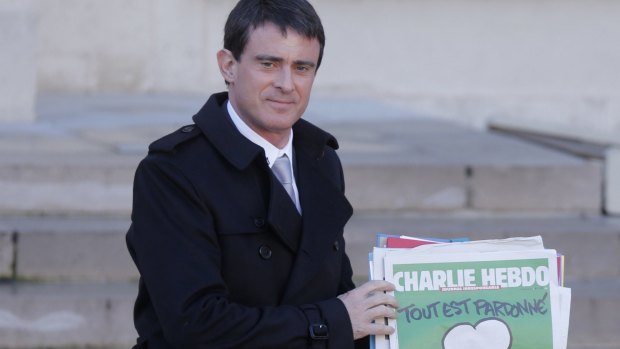 Visiting Marseille: French Prime Minister Manuel Valls holds a copy of Charlie Hebdo earlier in the year.