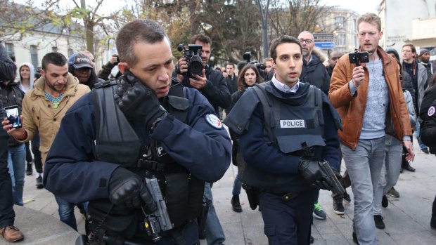 Journalists film police arriving at the scene of the shootout in Saint-Denis on Wednesday.