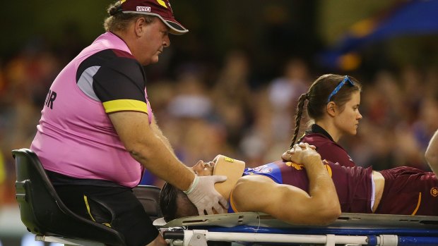 Knocked out: Stefan Martin of the Lions is stretchered from the field last weekend.
