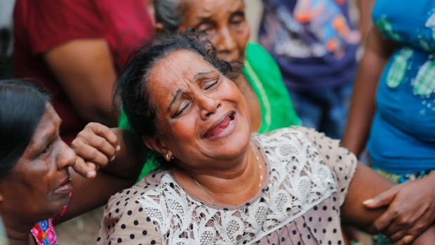 A Sri Lankan woman mourns lost  family members in the garbage dump collapse.