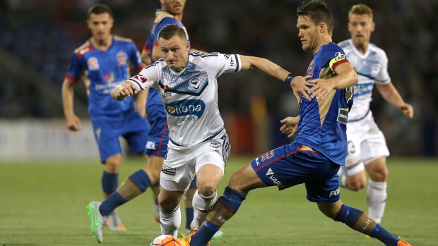 Nigel Boogaard of the Jets attempts to stop Besart Berisha of the Victory.