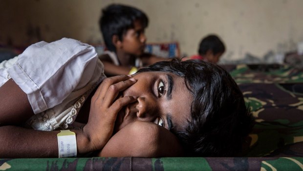 A Rohingya girl resting at a temporary refugee shelter in Aceh, Indonesia, in May.