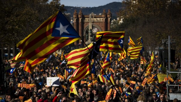 Pro independence demonstrators wave "esteladas" or pro independence flags, during a demonstrations to show public support for the Parliament of Catalonia, in Barcelona.