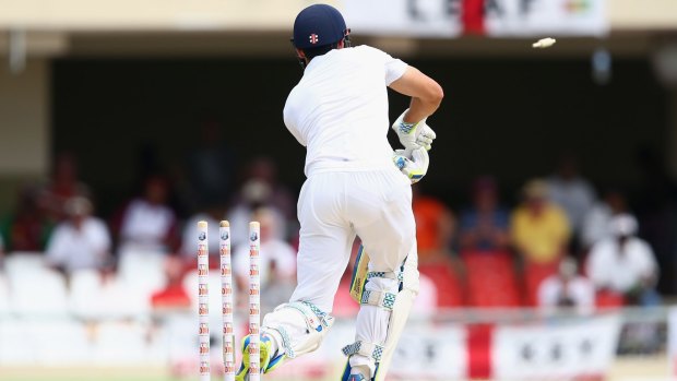 Cleaned up: Alastair Cook of England is bowled by Kemar Roach.