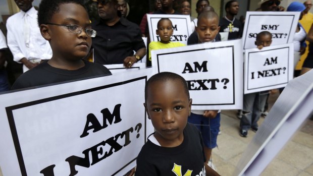 Alvin Duplessis, 10, left, and Thomas McGriff, 5, rally after unarmed black teenager Trayvon Martin was shot by George Zimmerman. 