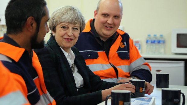 Theresa May talks to staff in a tea room at British Steel as she campaigns in North Lincolnshire on Wednesday.