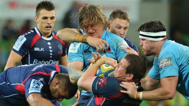 Melbourne Rebels' Toby Smith (with the ball) has signed a new deal with the club.