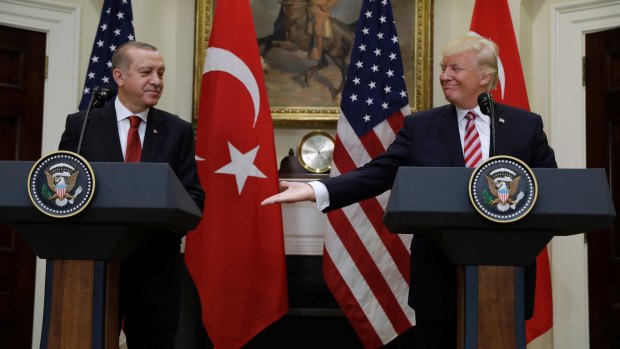 US President Donald Trump reaches to shake hands with Turkish President Recep Tayyip Erdogan in Washington on Tuesday.
