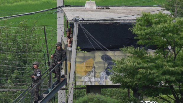 South Korean army soldiers step down from a military guard post in South Korea's Paju on Monday.