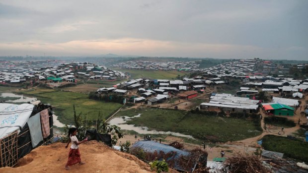 A Rohingya Muslim child, who crossed over from Myanmar into Bangladesh, plays in front of her makeshift tent on Friday.