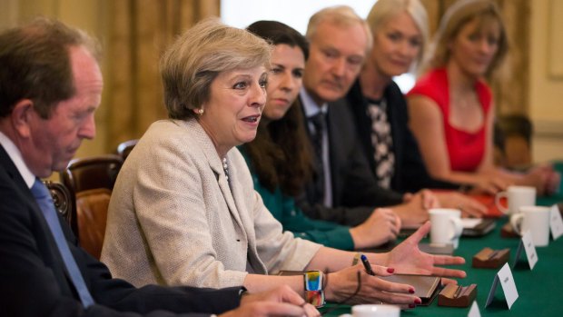 British Prime Minister Theresa May hosts a round table for small business representatives. She is said to have been unimpressed by ministerial "carrying-on".