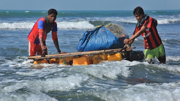 Rohingya fishermen pull a raft made of empty plastic containers along the coastline of the Bay of Bengal in Maungdaw, western Rakhine state after fishing boats were outlawed s part of a counter-insurgency campaign.